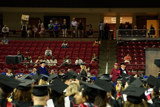 Carly Carpenter on stage getting handshake during graduation from the University of Denver.<br>June 3, 2016
