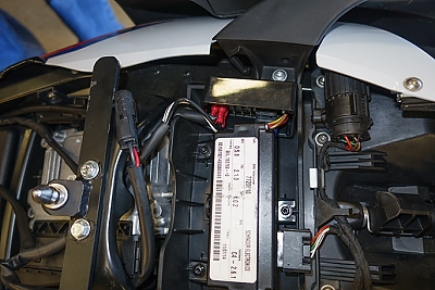 November 21, 2014<br>This image shows an aftermarket power distribution fuse block installed at tolp center. (It's a black box with wires coming out the side).  This powers the outlets added to the fairing as well as the heated seat.  It switches on and off with the bike.