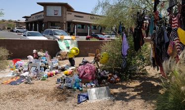 A few of some of the items left in memoriam at the March 25, 2010 accident site. Customers at the Walgreens in the background heard the horrific wreck and rushed to help, but were unable save everyone due to the fire which immediately engulfed the truck, motorcycles and some of the victims.