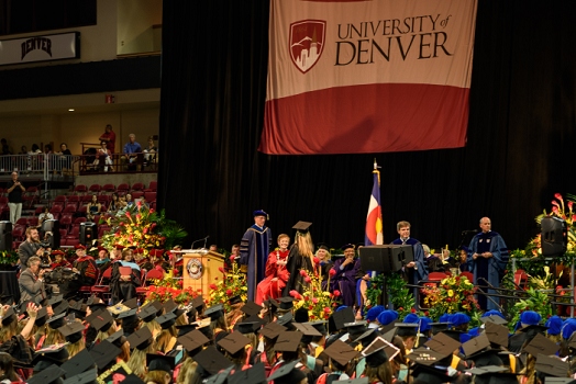 Carly Carpenter on stage getting handshake during graduation from the <br>June 3, 2016