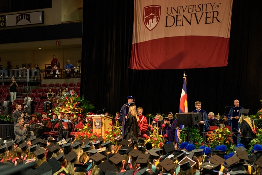 Carly Carpenter on stage getting handshake during graduation from the <br>June 3, 2016