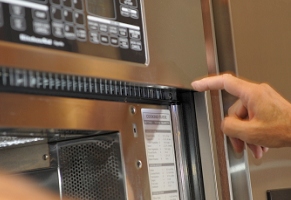 OK - now you have to remove the upper trim panel.  Three screws.  However, the upper trim panel slides in behind the upper (shiny steel) face plate, so the face plate must be removed.   To get the face plate off, you have to remove two steel trim strips on each side of the microwave/oven combo.