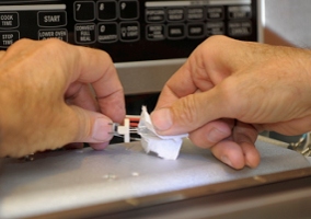 The bulb is halogen, so you should not touch it with your fingers and get oil on it.   Here Ron is putting the bulb back in the holder while gripping it with a bit of paper towel.