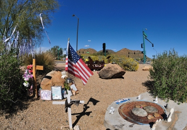 Exactly one year after the wreck.  Bandanas again cover a tree, and fresh flowers and articles have appeared at the memorial site.