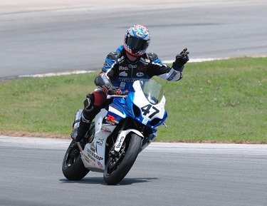 'Opie' Caylor waves to the crowd after winning the race