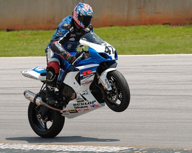 'Opie' Caylor wheelies after turn 5 to please the crowd on Spectator Hill