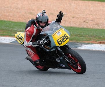 This rider has a helmet cam.  Many bikes had these cameras, mounted in all sorts of places.